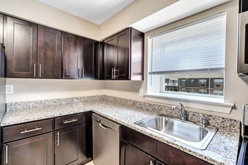 Hillsborough apartment for rent - A kitchen with brown cabinets and a stainless steel dishwasher and oven.