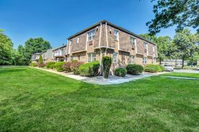Hillsborough apartment for rent - Exterior photo of Beekman Gardens in Hillsborough, showing a typical apartment building. Lush green landscaping and trees can be seen around the property.