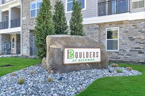 Monmouth Junction apartment for rent - Boulder at Beekman sign, featuring the community logo placed on a large boulder outside one of the apartment buildings