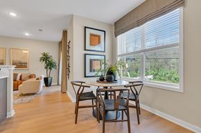 Monmouth Junction apartment for rent - Interior photo of the Boulders at Beekman showing the eat-in dining area with luxury vinyl flooring and a round table for 4 placed in front of a double window which allows for natural light.