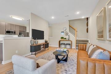 Monmouth Junction apartment for rent - A living room with a grey couch and a black coffee table.