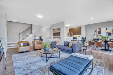 Ewing apartment for rent - A living room with a blue rug and a black chaise lounge.