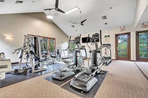 Belle Mead apartment for rent - Interior photo of the Pike Run Community Clubhouse, showing the indoor gym with various pieces of cardio and strength training equipment.