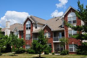 Belle Mead apartment for rent - Pike Run Village Exterior photo showing several balconies. Several bushes and trees highlight the landscape.