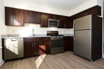 Belle Mead apartment for rent - A kitchen with a refrigerator, oven, and microwave.