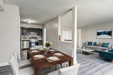 Wilmington apartment for rent - A modern dining room with a wooden table set for two.