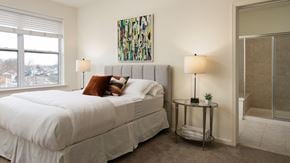 Bound Brook apartment for rent - A bedroom with a large bed and a painting on the wall.