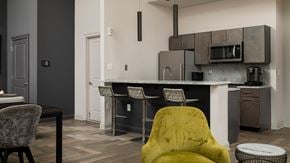 Philadelphia apartment for rent - A yellow chair sits in front of a kitchen island.