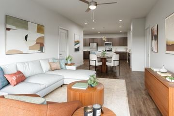 Kissimmee apartment for rent - A modern living room with a white couch and a wooden coffee table.