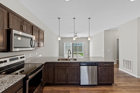 Harrison apartment for rent - a kitchen with granite counter tops and wooden cabinets