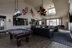 Bound Brook apartment for rent - Elegant clubhouse at Queens Gate Apartments featuring a pool table, cozy lounge area, and stylish decor.