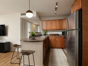 Plainsboro apartment for rent - A kitchen with wooden cabinets and a refrigerator.
