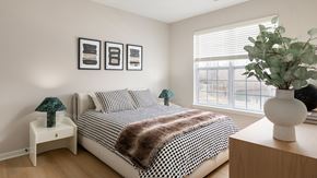 Princeton apartment for rent - A bedroom with a bed, nightstands, and a plant.