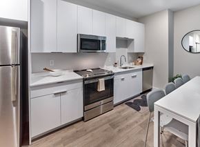 Rahway apartment for rent - Fully equipped modern kitchen in a studio apartment at The Mint Rahway, perfect for those seeking luxury apartment rental with an open floor plan.