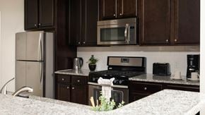 Bound Brook apartment for rent - A kitchen with brown cabinets and a stainless steel refrigerator.