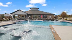Justin apartment for rent - A pool with a fountain in the middle of it.