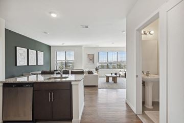 Middlesex apartment for rent - an open kitchen and living room with a sink and a table