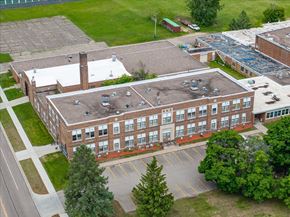 St. Paul Park apartment for rent - A large brick building with a parking lot in front.