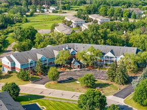Woodbury apartment for rent - A large building with a parking lot in front of it.
