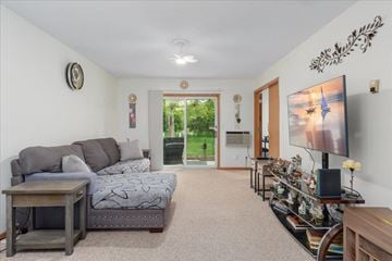 Scandia apartment for rent - A living room with a grey couch and a television.