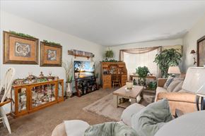 Forest Lake apartment for rent - A living room with a couch, chair, and a fireplace.
