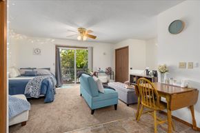 Stillwater townhouse for rent - A bedroom with a bed, chair, and table.