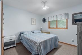 Scandia apartment for rent - A bedroom with a bed, nightstand, and window.