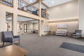 Stillwater apartment for rent - A spacious waiting room with a couch, chairs, and a coffee table.