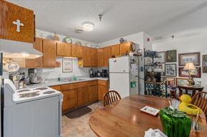 St. Paul Park apartment for rent - A kitchen with wooden cabinets and a white refrigerator.