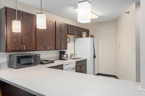 Woodbury apartment for rent - A kitchen with brown cabinets and a white counter.