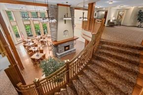 Forest Lake apartment for rent - A large, well-lit living room with a staircase leading to the upper floor.