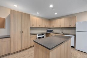 Stillwater apartment for rent - A kitchen with wooden cabinets and a black countertop.