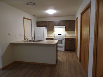 Oakdale townhouse for rent - A kitchen with wooden floors and white appliances.