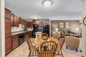 Mahtomedi apartment for rent - A kitchen with a table and chairs in the foreground.