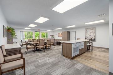 Hugo apartment for rent - A modern kitchen with a dining table and chairs.