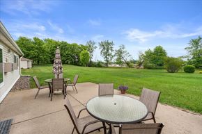Hugo apartment for rent - A patio with a table and chairs is set up outside.