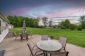 Hugo apartment for rent - A patio with a table and chairs is set up for an evening outside.