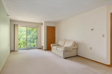 Woodbury apartment for rent - A living room with a white couch and a sliding glass door.