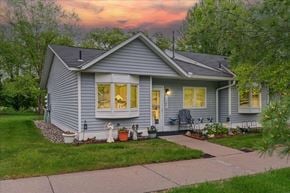 Scandia apartment for rent - A house with a grey exterior and a white door is shown.