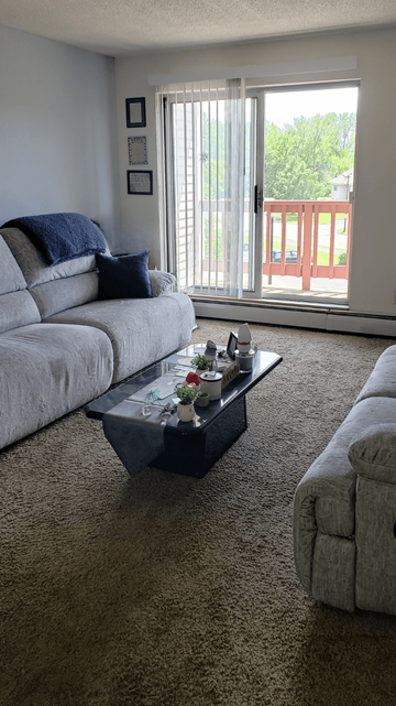 Oakdale apartment for rent - a living room with couches and a coffee table
