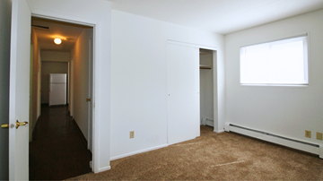 St. Paul Park apartment for rent - a bedroom with a carpeted floor and a door to a hallway and a closet