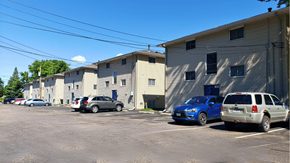 St. Paul Park apartment for rent - a parking lot filled with cars in front of buildings