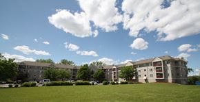 Oakdale apartment for rent - an exterior view of an apartment building on a green lawn