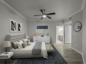Carrollton townhouse for rent - Bedroom with crown molding, ceiling fan, en suite bathroom entry, and wood-style flooring.