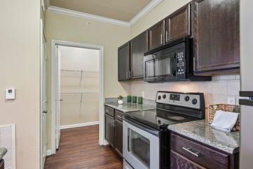Fort Worth apartment for rent - A kitchen with a black microwave above the stove.