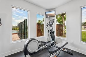 Venice apartment for rent - A home gym with a stationary bike and a view of the backyard through the windows.