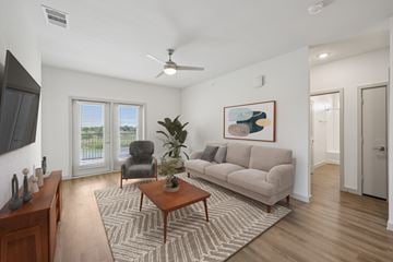 Farmersville apartment for rent - A living room with a couch, chair, and a painting on the wall.