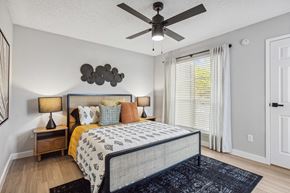 Carrolton apartment for rent - a bedroom with a bed and a ceiling fan
