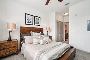 Gainesville apartment for rent - A bedroom with a large bed and two lamps.
