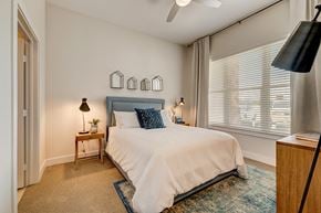 Farmers Branch apartment for rent - a bedroom with a bed and a large window
